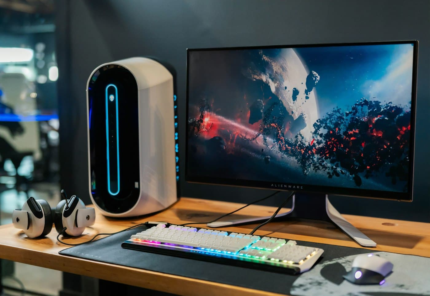 Gaming desktop with a white tower, a wide monitor, RGB keyboard, and visible cables